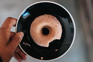 An aerial view of our sugar donut on a small, black plate.