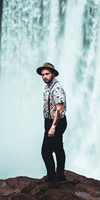 moody portrait with waterfall background