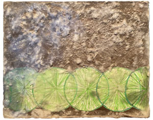 Wooden board with green line slives covered in textured wax in white and blue.