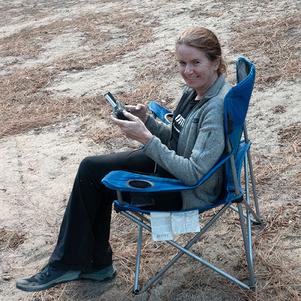A photo of me sitting in a chair flying a drone
