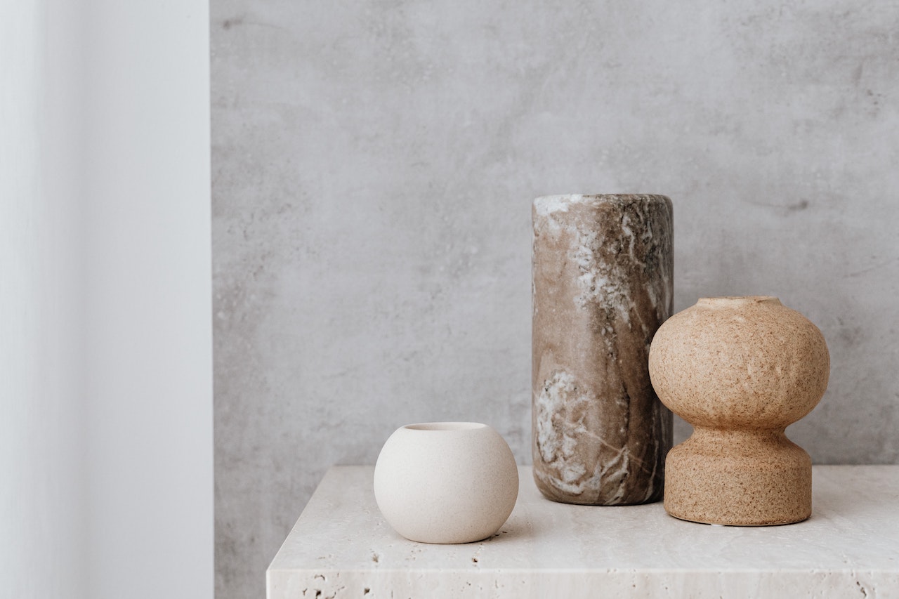 Three decorative trinkets sit atop a console