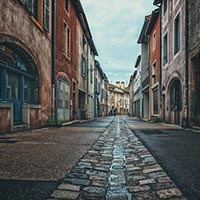 An empty cobblestone street in a historic town. 