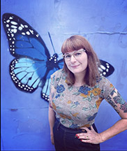 Myself standing in front of a painting of a butterfly
