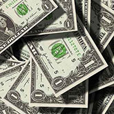 Small pile of one dollar bills up close.