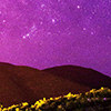 Purple night sky behind hills