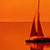 Orange sunsut with sailing boat
