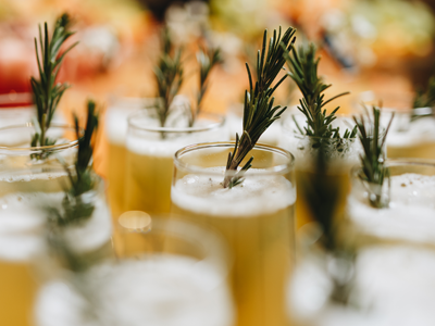 fancy drinks garnished with rosemary sprigs