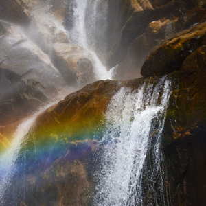 small waterfall with a rainbow