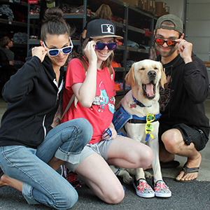 silly picture of three people with glasses and a dog wearing tennis shoes yawning