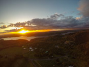 the sun setting under thunderstorms
